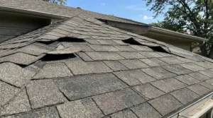 Roof inspection showing wind damage, lifted shingles, and aging roof materials.